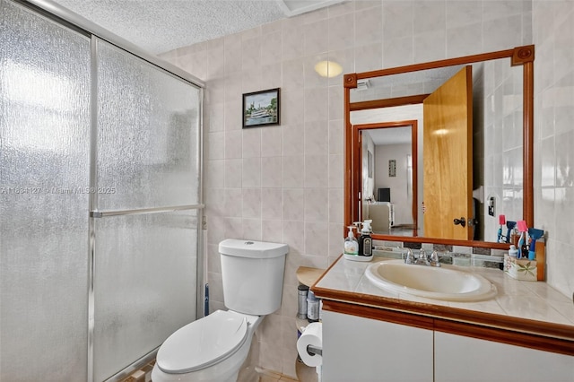 14355 SW 158th St, Miami, FL 33177 - bathroom with tile walls, a stall shower, vanity, and a textured ceiling