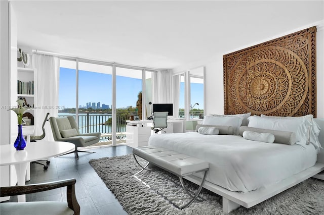 770 NE 69th St Unit 4I, Miami, FL 33138 - bedroom with access to exterior, floor to ceiling windows, and a desk