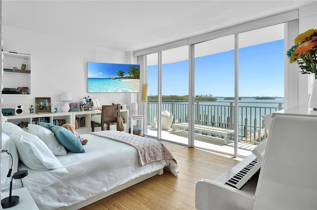 770 NE 69th St Unit 4I, Miami, FL 33138 - bedroom featuring access to exterior, expansive windows, and wood finished floors