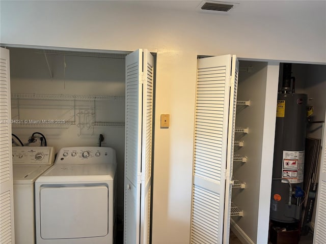 10234 NW 57th St, Doral, FL 33178 - laundry area with water heater, washer and clothes dryer, and attic access