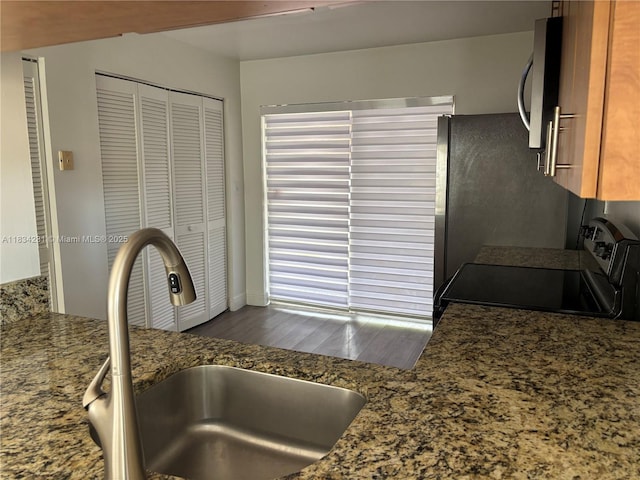 10234 NW 57th St, Doral, FL 33178 - kitchen view of stainless steel appliances, dark wood-style floors, and stone counters