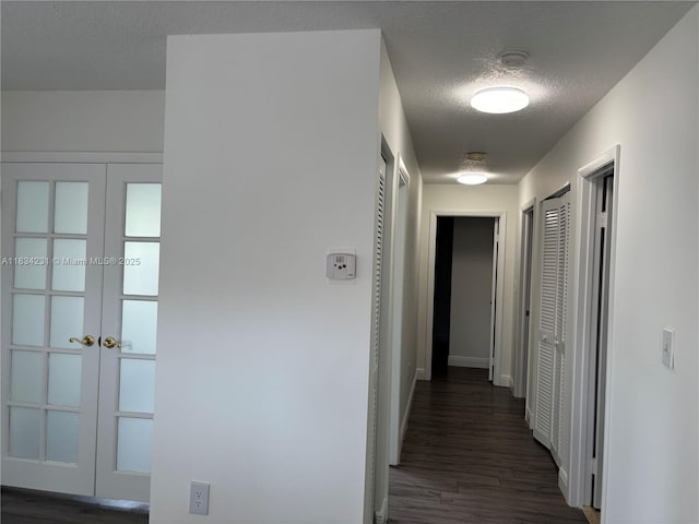 10234 NW 57th St, Doral, FL 33178 - hall featuring french doors, a textured ceiling, and dark wood finished floors