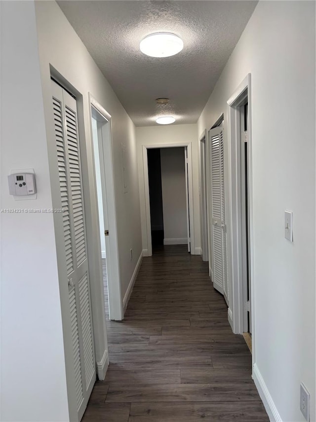 10234 NW 57th St, Doral, FL 33178 - hall with a textured ceiling and dark wood-type flooring