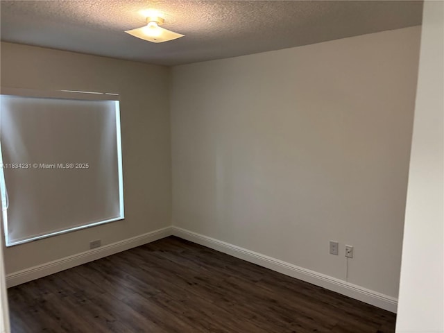 10234 NW 57th St, Doral, FL 33178 - spare room featuring dark wood-style floors and a textured ceiling