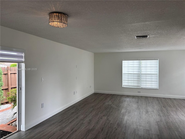 10234 NW 57th St, Doral, FL 33178 - unfurnished room featuring dark wood-style flooring, healthy amount of natural light, and a textured ceiling