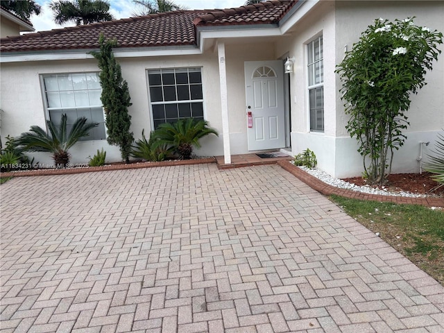 10234 NW 57th St, Doral, FL 33178 - property entrance featuring stucco siding and a tiled roof