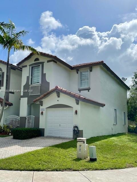 6293 SW 165th Ave, Miami, FL 33193 - mediterranean / spanish house with a tiled roof, stucco siding, driveway, a front lawn, and an attached garage