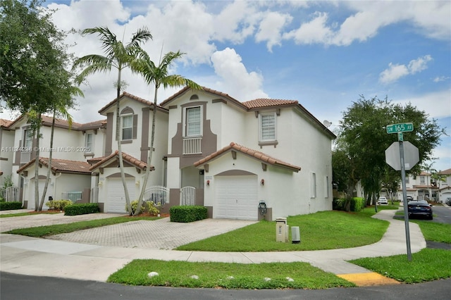 6293 SW 165th Ave, Miami, FL 33193 - mediterranean / spanish house with an attached garage, a tiled roof, decorative driveway, stucco siding, and a front lawn