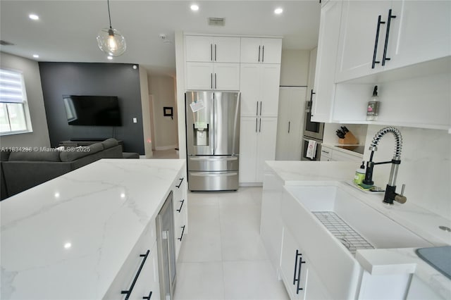 6293 SW 165th Ave, Miami, FL 33193 - kitchen with stainless steel appliances, open floor plan, white cabinetry, light stone countertops, and recessed lighting