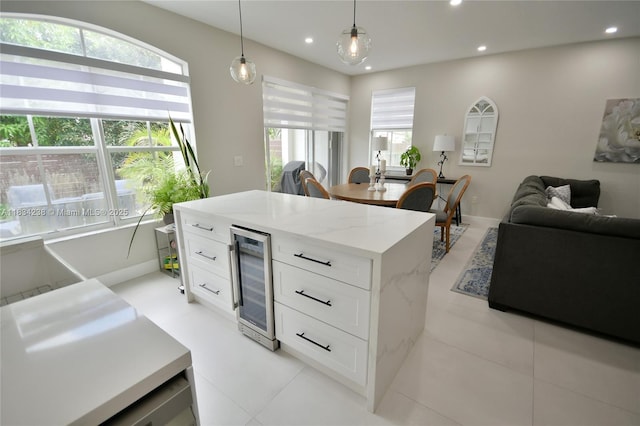 6293 SW 165th Ave, Miami, FL 33193 - kitchen featuring wine cooler, recessed lighting, hanging light fixtures, white cabinets, and open floor plan
