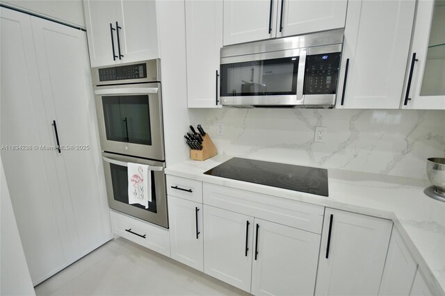 6293 SW 165th Ave, Miami, FL 33193 - kitchen with stainless steel appliances, white cabinetry, decorative backsplash, and light stone counters