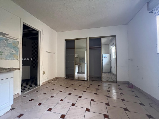 1555 W 44th Pl Unit 103, Hialeah, FL 33012 - unfurnished bedroom with baseboards and a textured ceiling
