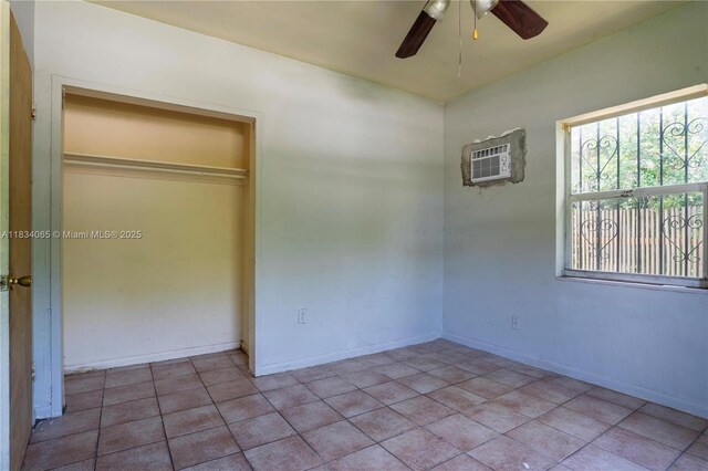 3255 William Ave, Miami, FL 33133 - unfurnished bedroom featuring a wall mounted AC, tile patterned floors, a closet, and a ceiling fan