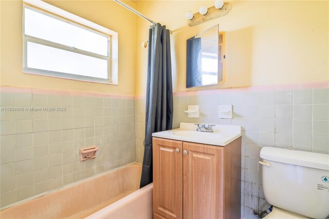 3255 William Ave, Miami, FL 33133 - full bathroom with plenty of natural light, tile walls, vanity, a wainscoted wall, and shower / bath combo with shower curtain