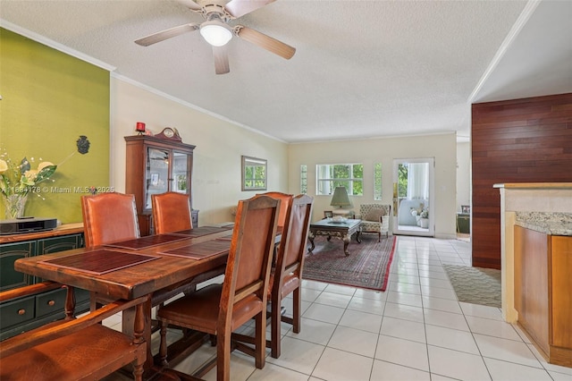 4350 Hillcrest Dr Unit 303, Hollywood, FL 33021 - dining area with crown molding, a textured ceiling, ceiling fan, light tile patterned flooring, and a fireplace
