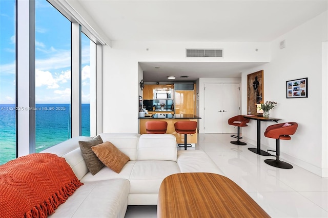 6899 Collins Ave Unit 2004, Miami Beach, FL 33141 - living area featuring light tile patterned floors and a water view