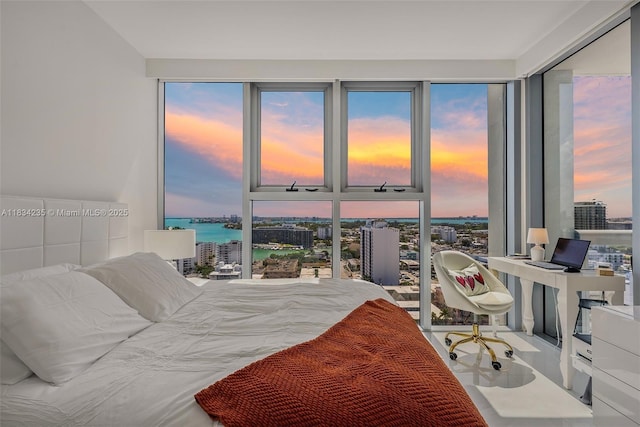 6899 Collins Ave Unit 2004, Miami Beach, FL 33141 - bedroom featuring a water view, a desk, multiple windows, and a city view