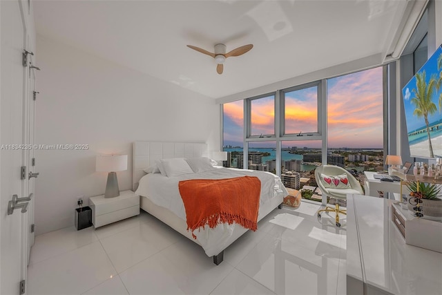 6899 Collins Ave Unit 2004, Miami Beach, FL 33141 - bedroom featuring floor to ceiling windows, light tile patterned floors, and a ceiling fan