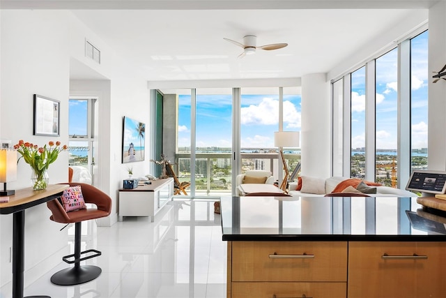 6899 Collins Ave Unit 2004, Miami Beach, FL 33141 - kitchen featuring tile patterned floors, dark countertops, ceiling fan, modern cabinets, and a wall of windows