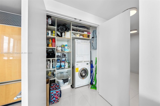 6899 Collins Ave Unit 2004, Miami Beach, FL 33141 - laundry area featuring stacked washing machine and dryer and tile patterned flooring