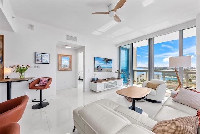 6899 Collins Ave Unit 2004, Miami Beach, FL 33141 - living room featuring ceiling fan, light tile patterned floors, and expansive windows