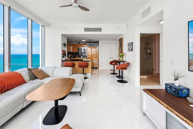 6899 Collins Ave Unit 2004, Miami Beach, FL 33141 - living room featuring a ceiling fan, a water view, and light tile patterned flooring