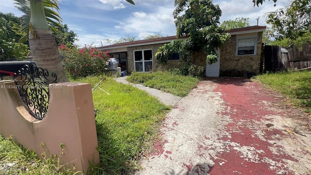 7080 Hope St, Hollywood, FL 33024 - view of front of property featuring stone siding and driveway