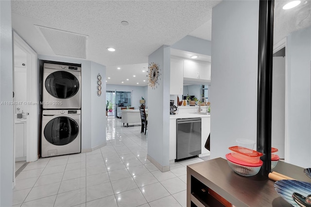 571 SW 142nd Ave Unit 410O, Pembroke Pines, FL 33027 - laundry room featuring stacked washer / drying machine, light tile patterned floors, a textured ceiling, and recessed lighting