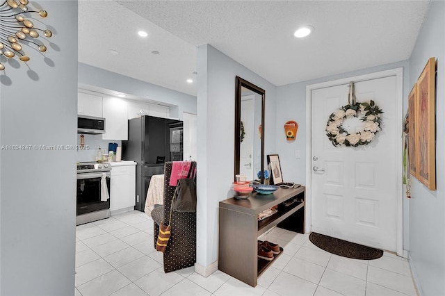 571 SW 142nd Ave Unit 410O, Pembroke Pines, FL 33027 - entrance foyer featuring light tile patterned floors, recessed lighting, and a textured ceiling