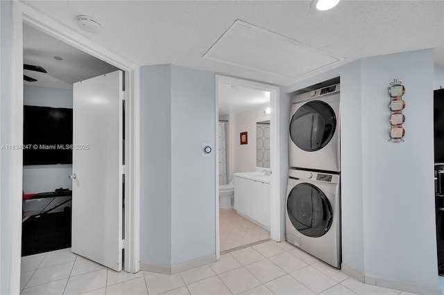 571 SW 142nd Ave Unit 410O, Pembroke Pines, FL 33027 - washroom with stacked washing machine and dryer and a textured ceiling