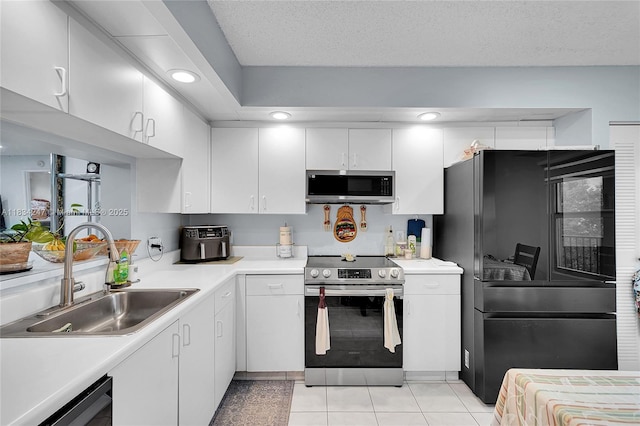 571 SW 142nd Ave Unit 410O, Pembroke Pines, FL 33027 - kitchen featuring appliances with stainless steel finishes, light countertops, white cabinets, light tile patterned floors, and recessed lighting