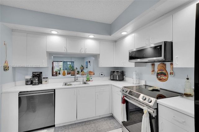 571 SW 142nd Ave Unit 410O, Pembroke Pines, FL 33027 - kitchen featuring stainless steel appliances, white cabinetry, light countertops, and recessed lighting