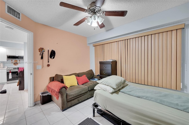 571 SW 142nd Ave Unit 410O, Pembroke Pines, FL 33027 - bedroom with a textured ceiling, light tile patterned floors, and a ceiling fan