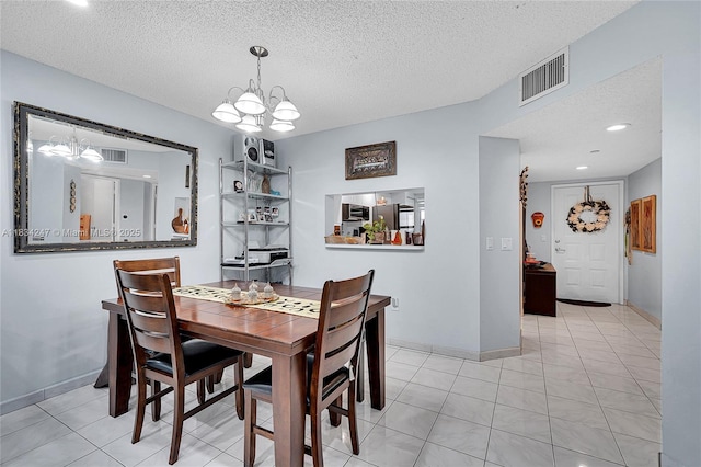 571 SW 142nd Ave Unit 410O, Pembroke Pines, FL 33027 - dining space featuring a chandelier, a textured ceiling, and tile patterned flooring