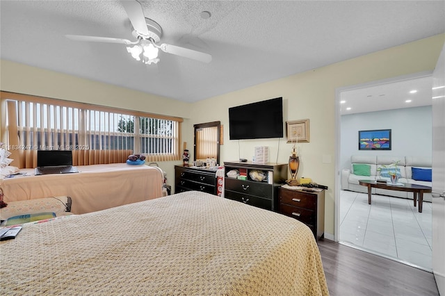 571 SW 142nd Ave Unit 410O, Pembroke Pines, FL 33027 - bedroom featuring wood finished floors, ceiling fan, and a textured ceiling