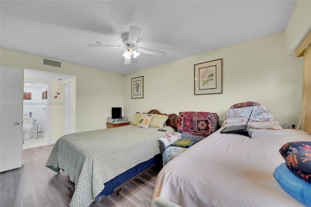 571 SW 142nd Ave Unit 410O, Pembroke Pines, FL 33027 - bedroom featuring wood finished floors, a ceiling fan, and a textured ceiling