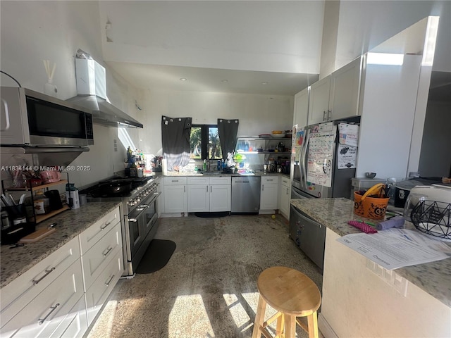 5900 NE 21st Ln, Fort Lauderdale, FL 33308 - kitchen with appliances with stainless steel finishes, ventilation hood, and light stone countertops