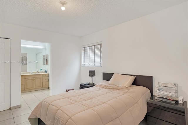 9723 Hammocks Blvd Unit 102, Miami, FL 33196 - bedroom featuring light tile patterned floors, a textured ceiling, and ensuite bath