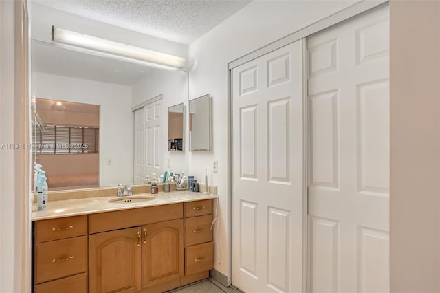 9723 Hammocks Blvd Unit 102, Miami, FL 33196 - bathroom featuring vanity, connected bathroom, and a textured ceiling