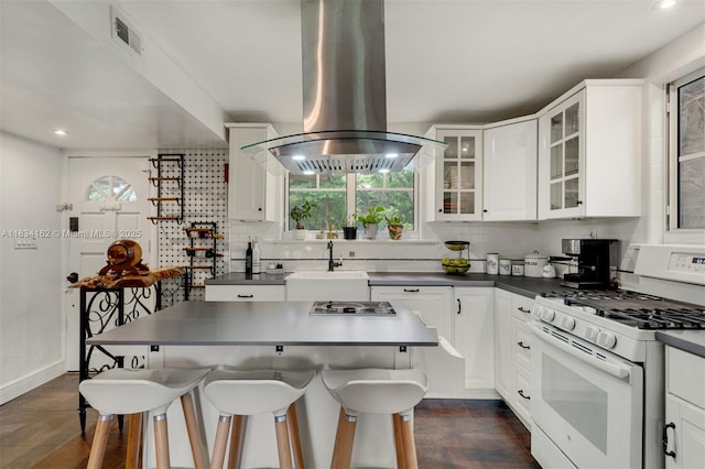 7997 SW 98th Ter, Miami, FL 33156 - kitchen with white gas range oven, island range hood, plenty of natural light, dark countertops, and recessed lighting