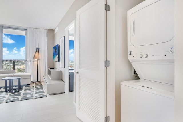 4010 S Ocean Dr Unit R1406, Hollywood, FL 33019 - laundry area with stacked washer / dryer and plenty of natural light
