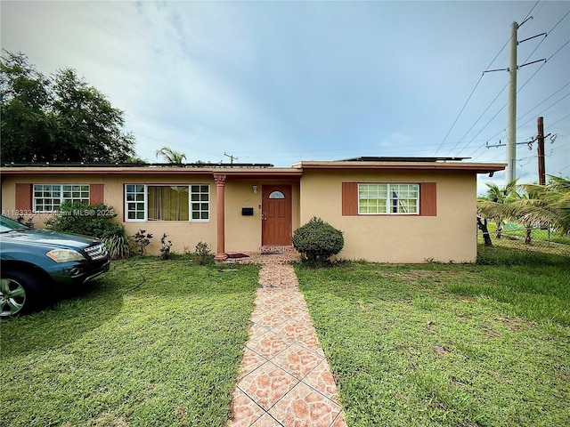 701 NW 176th Ter, Miami Gardens, FL 33169 - ranch-style house featuring solar panels and stucco siding