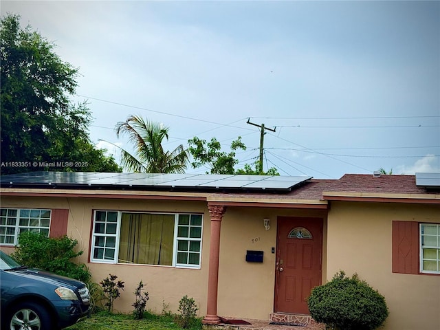 701 NW 176th Ter, Miami Gardens, FL 33169 - ranch-style house featuring solar panels and stucco siding