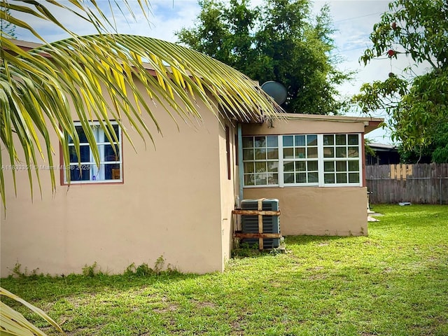 701 NW 176th Ter, Miami Gardens, FL 33169 - view of side of property with stucco siding and a central AC unit