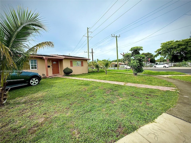 701 NW 176th Ter, Miami Gardens, FL 33169 - view of front of house featuring stucco siding and a front yard