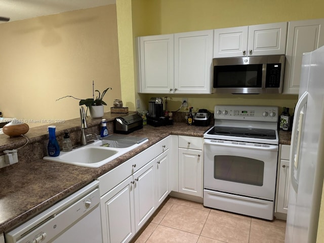 9267 SW 227th St Unit 5-8, Cutler Bay, FL 33190 - kitchen featuring white appliances, dark countertops, white cabinets, and light tile patterned floors