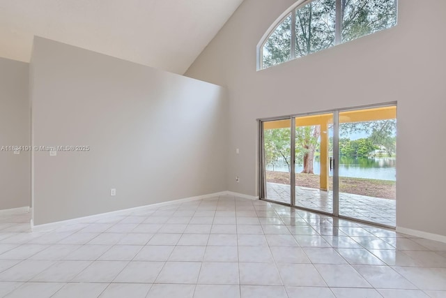 12700 SW 18th St, Miramar, FL 33027 - unfurnished room with plenty of natural light, a towering ceiling, light tile patterned flooring, and a water view