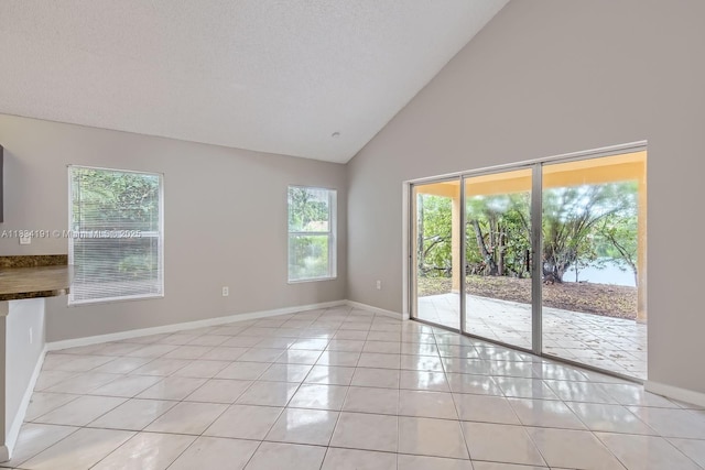 12700 SW 18th St, Miramar, FL 33027 - empty room featuring light tile patterned flooring and high vaulted ceiling