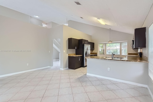 12700 SW 18th St, Miramar, FL 33027 - kitchen with stainless steel refrigerator with ice dispenser, high vaulted ceiling, a peninsula, light tile patterned floors, and decorative light fixtures