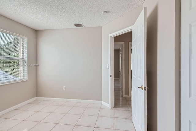 12700 SW 18th St, Miramar, FL 33027 - spare room with a textured ceiling and light tile patterned flooring